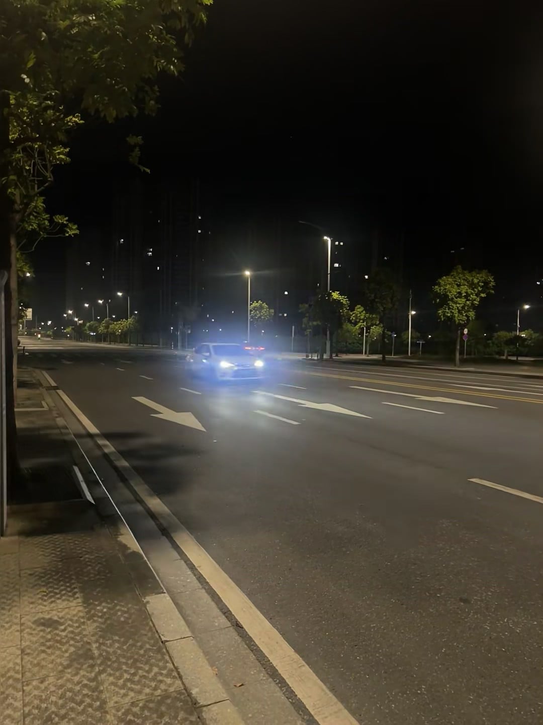 深夜路灯下，一辆车的蓝光像在追梦